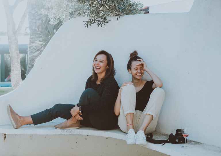 Two women sitting on white bench friendship unpacked: the core qualities that define genuine friends