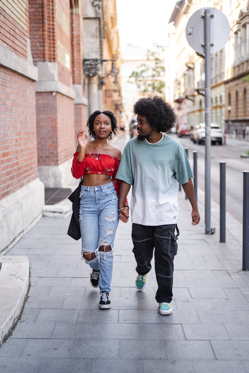 Couple walking on a pavement holding hands