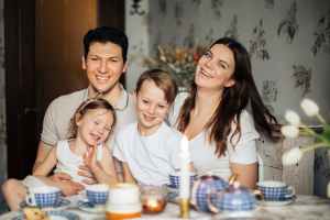 loving family time laughing at table having cozy meal