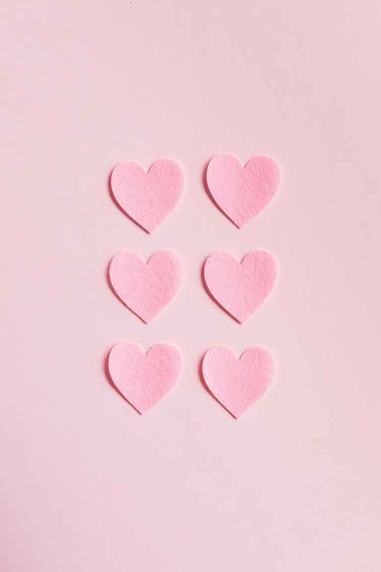 Heart shaped cutouts on pink background relationship styles