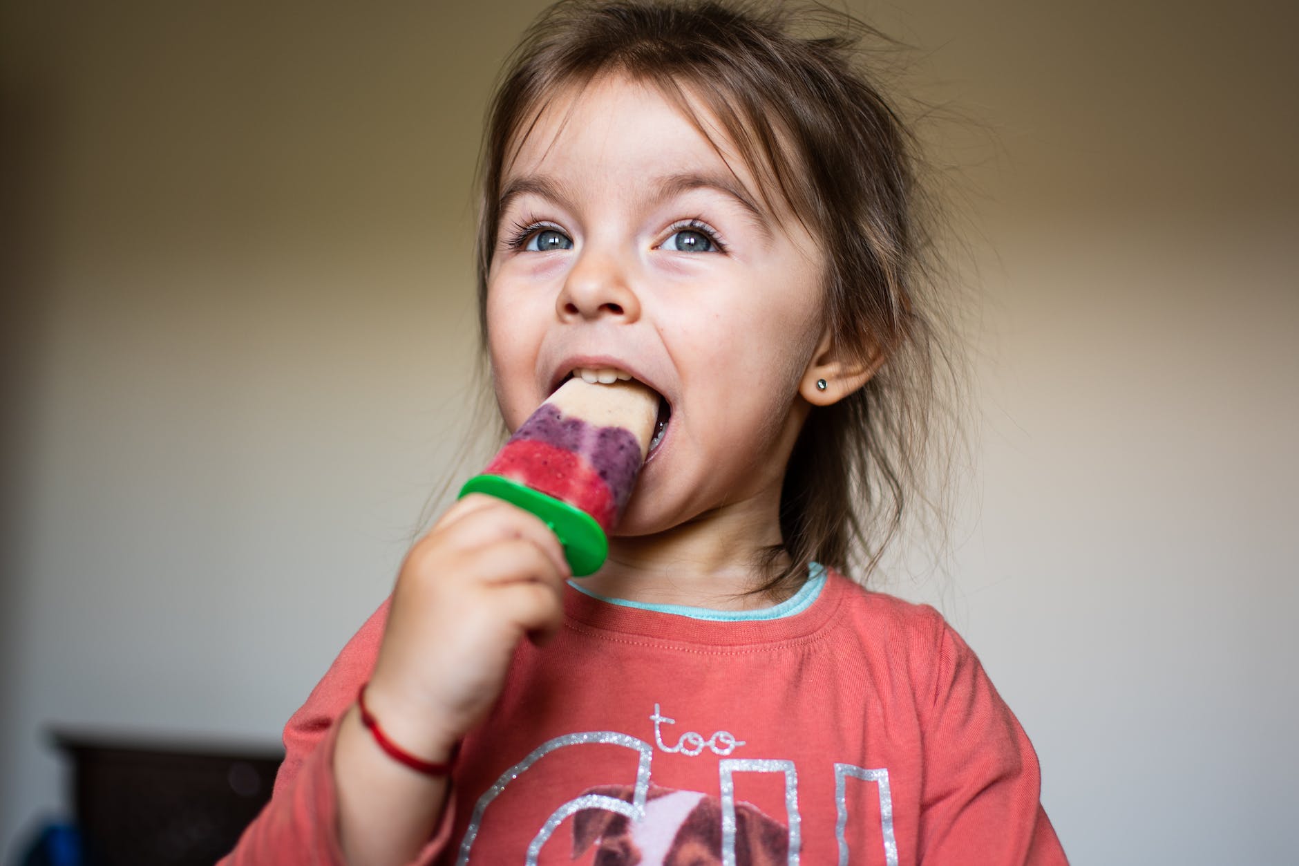 Girl eating popsicle kid-friendly healthy recipes