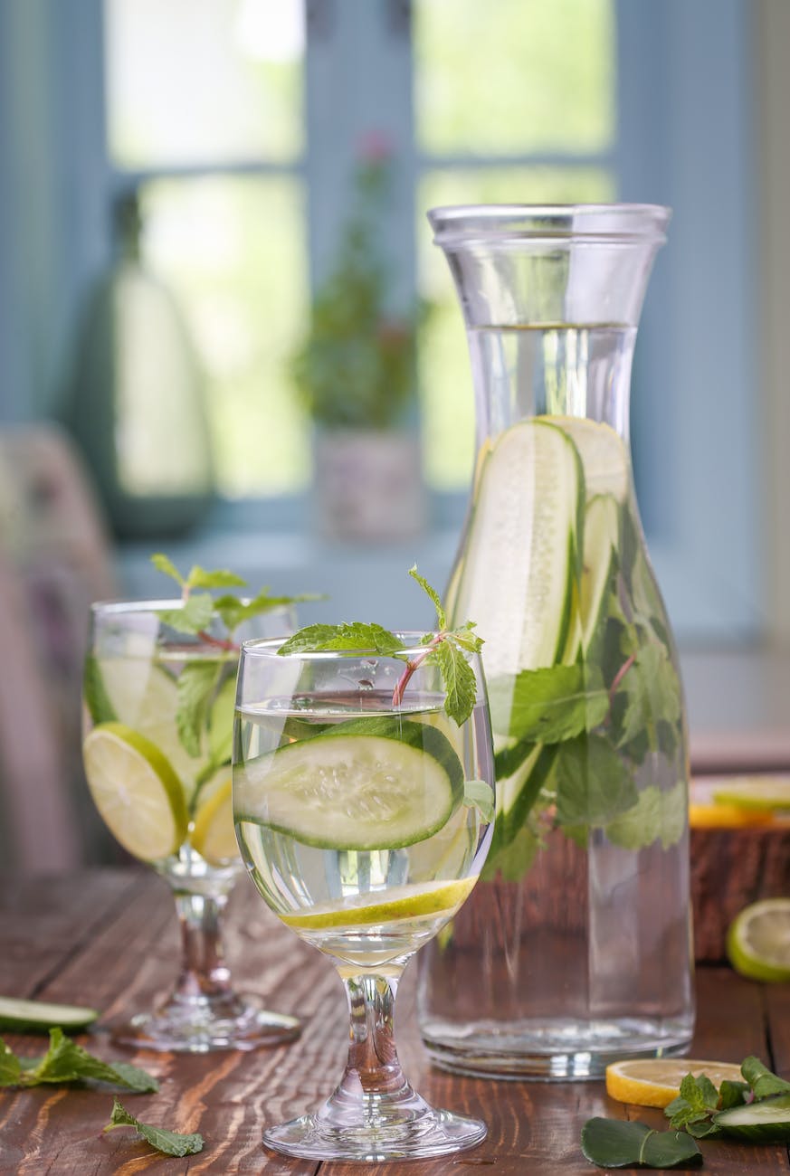 Clear glass bottle with lemon and cucumber lemonade morning beverages
