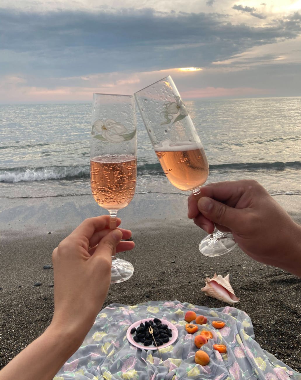 Couple clinking glasses of champagne on seashore thriving relationship