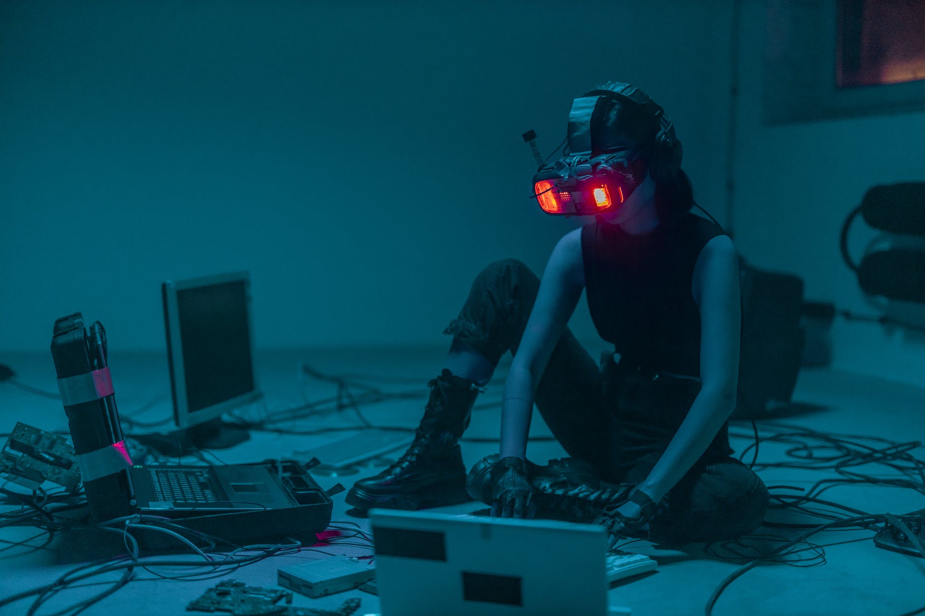 A person sitting on the floor with vr goggles using a computer parental controls