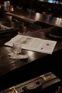 black hat and newspaper on wooden counter financial education