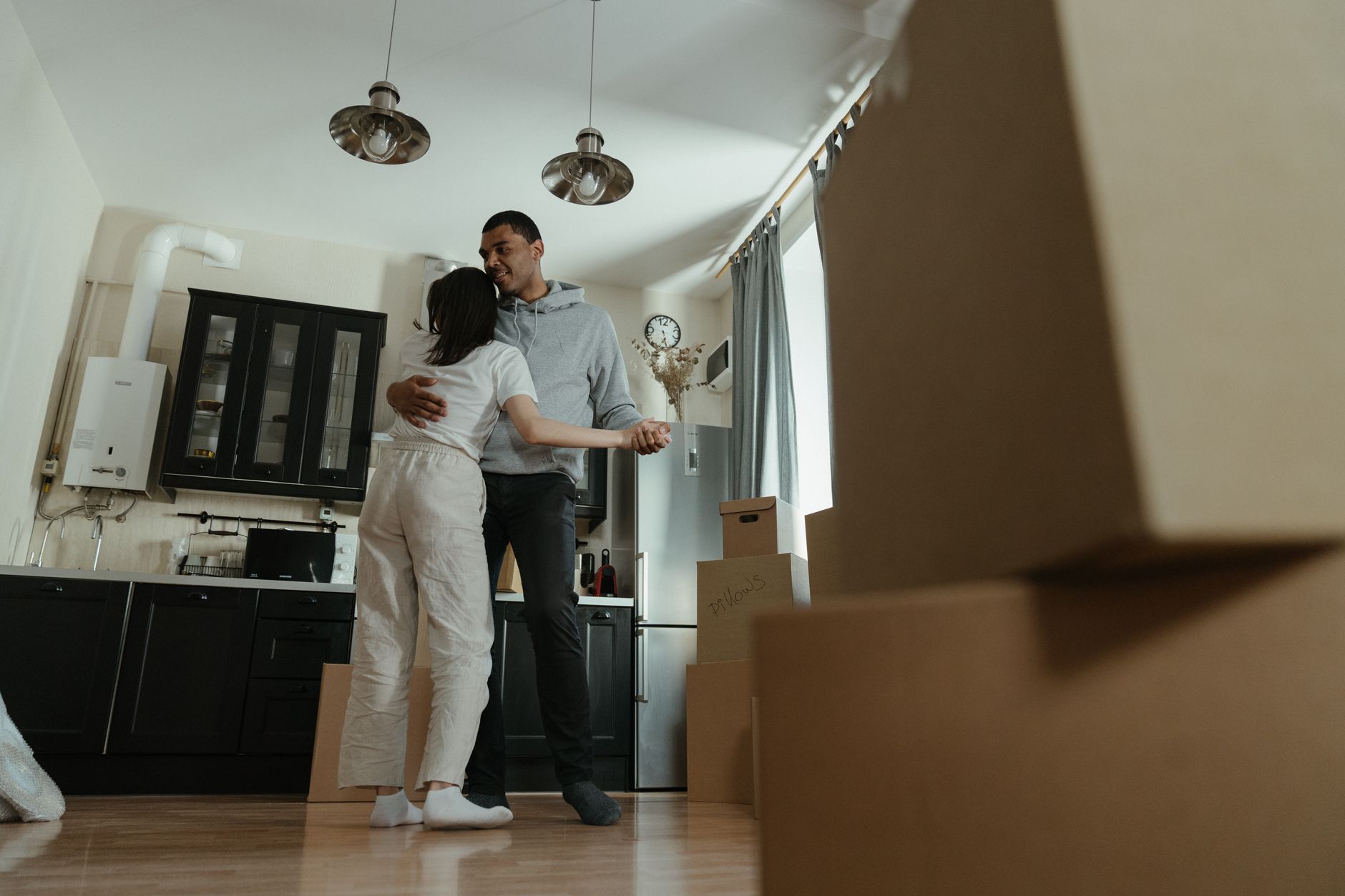 First Apartment Move-In Guide featured image: first apartment moving boxes kitchen towels cleaning supplies move in